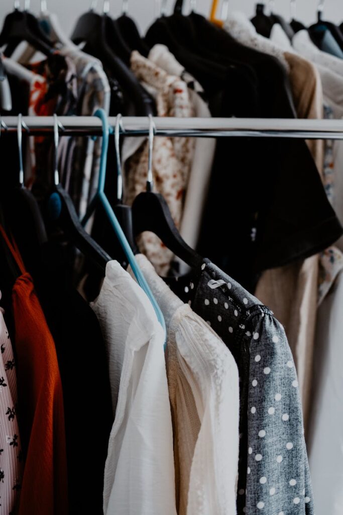 A diverse collection of clothing hanging neatly on racks, showcasing vibrant colors and patterns.